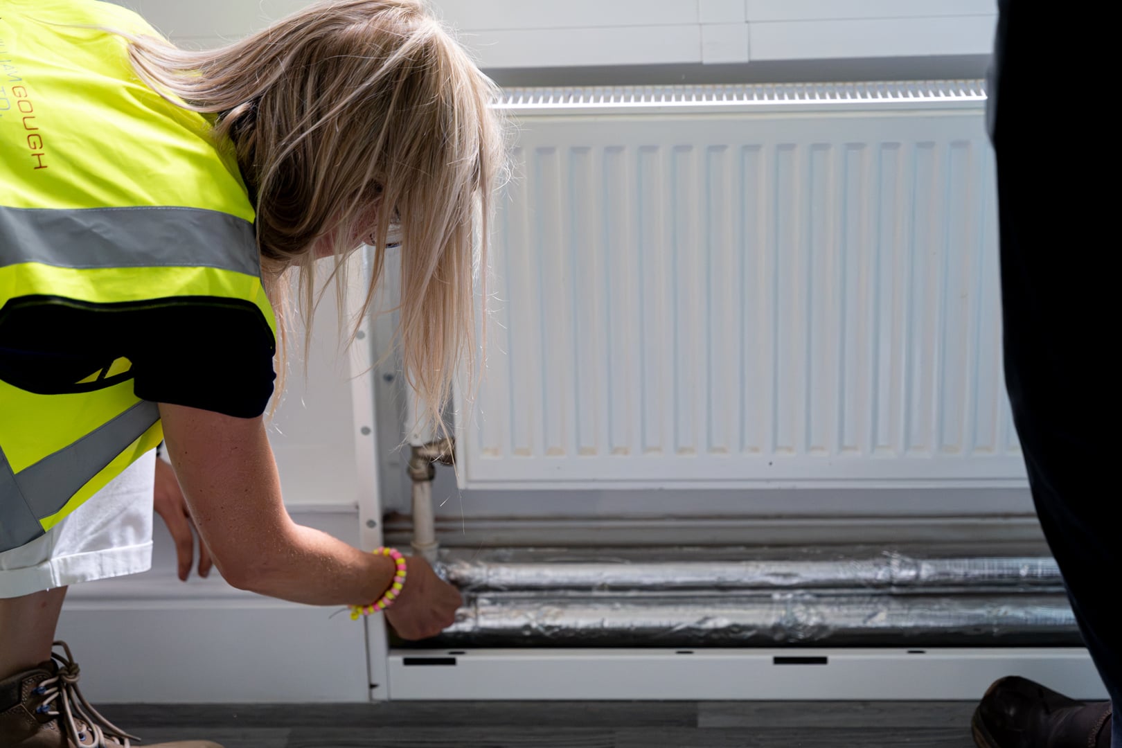 person checking out open radiator cover